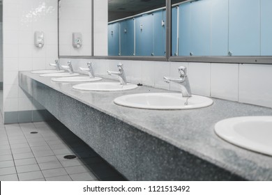 Public Toilet And Bathroom Interior With Wash Basin And Sink Or Lavatory, Close - Up Of The Wash Bowl And Wash Basin With The Stain Dirty In The Toilet.