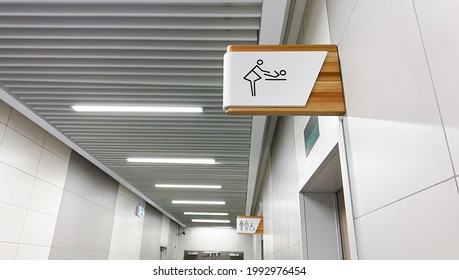 Public toilet sign for restroom. Baby changing facilities and feeding area. Men, women and disabled lavatory  on blurred background - Shutterstock ID 1992976454