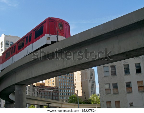 Public transit system in city. Moving
between buildings. Horizontally framed
shot.