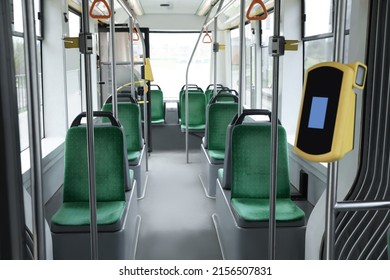 Public transport interior with comfortable green seats and contactless fare payment devices