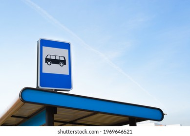 Public Transport Stop Sign On Light Blue Sky Outside, Copy Space. Bus Station On The Route