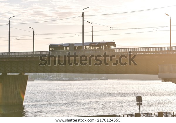 Public
transportation bus in sunset light on Vansu Bridge from Riga.
Transportation industry in Latvia,
2022.