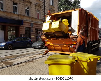 A Public Utility Worker Collects Garbage From Garbage Cans In A Garbage Truck In The Historic City. Ecology Of City Life. Waste Management In The Modern World. Prestigious And Affordable Work.