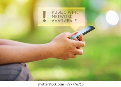 Public wi-fi network available message on smartphone in female hands, wireless internet hotspot in park