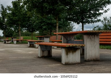 Public Wooden And Concrete Benches In A Park And Motorway Service Area