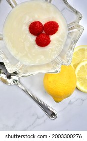 Pudding with lemon, raspberry, and a spoon
