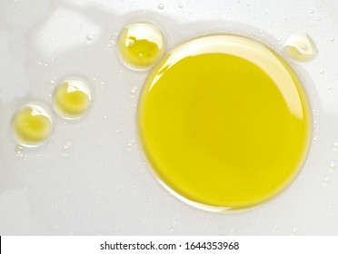 Puddle Of Natural Olive Oil In Water Background, Top View