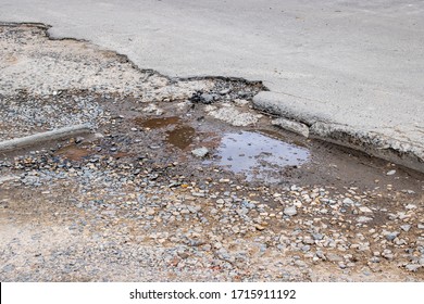 Puddle in a pit on an asphalt road
