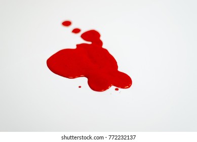 Puddle Of A Red Paint Spill On The White Background