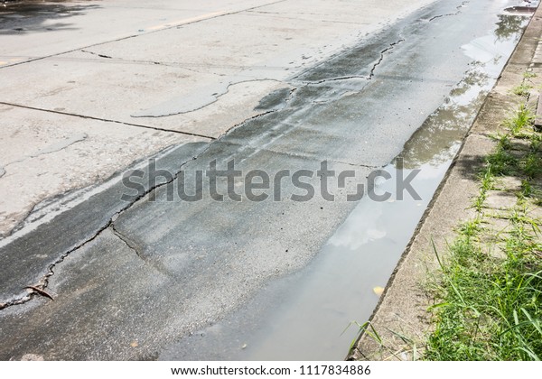Puddle Water on Crack road, flooded and road, Asphalt\
road cracks 
