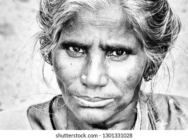 PUDUCHERRY, INDIA - DECEMBER Circa, 2018. Unidentified Portrait Close Up Of Old Face Indian Woman Outdoor In Village, Very Serious Sad. Black And White Image