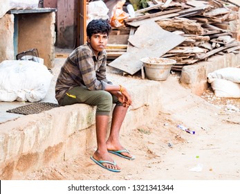 PUDUCHERY, INDIA - DECEMBER Circa, 2019. Portrait Of Unidentified Sad Lonely Teenager Boy Sitting In A Poor Village