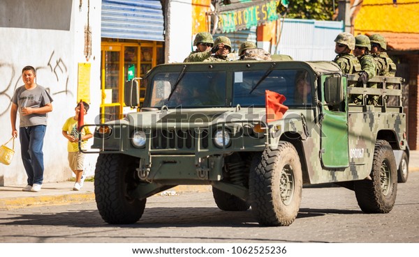 Puebla, Mexico - 11/21/2016: Mexican soldiers\
travelling in army\
vehicle