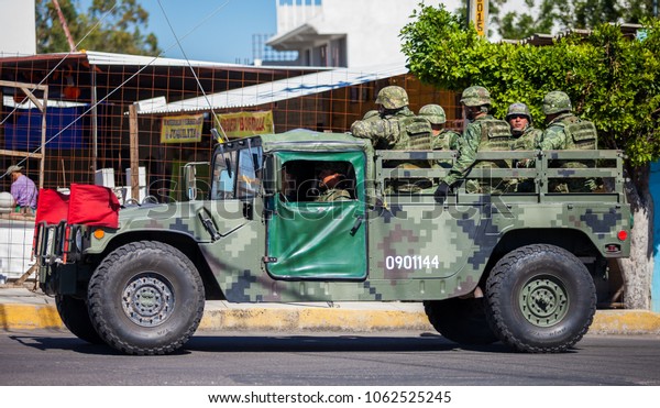 Puebla, Mexico - 11/21/2016: Mexican soldiers\
travelling in army\
vehicle