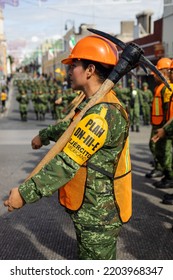 Puebla, Mexico - September 16, 2022: Military Woman Loads A Pickaxe In Plan DN3