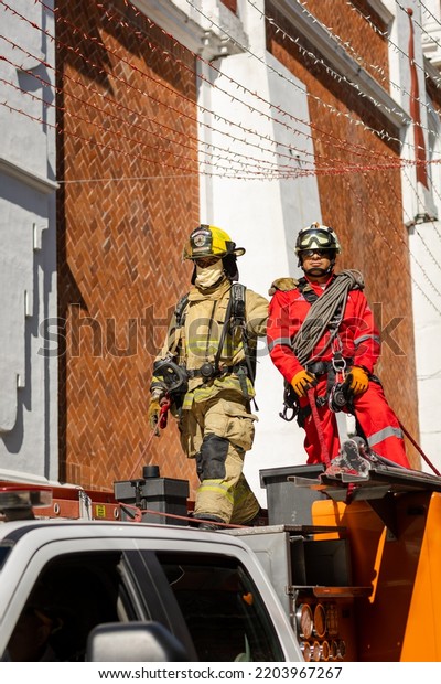 Puebla, Mexico - September 16,\
2022: Civil Protection rescuers from Puebla parade through the\
streets