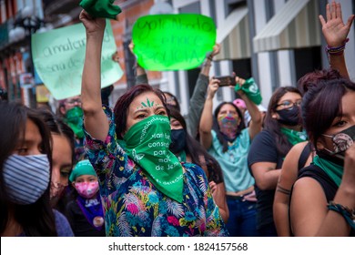 Puebla, Mexico - September 28, 2020: With green scarves, members of feminist collectives demonstrate in the streets of the Historic Center of Puebla to demand the legalization of abortion.
