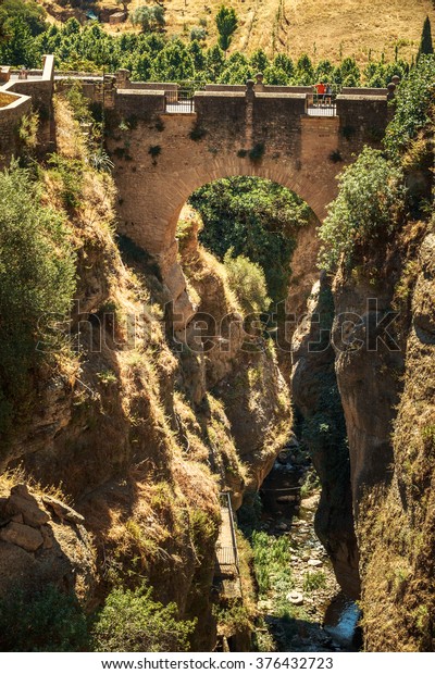 The\
Puente Viejo - Old Bridge is oldest and smallest of three bridges\
that span the 120-metre deep chasm that carries Guadalevin River\
and divides city of Ronda, Province Of Malaga,\
Spain