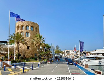 Puerto Banus, Marbella, Spain -  January 31, 2022: watchtower and luxury jachts, luxury shops and restaurants in exclusive place on the Costa del Sol