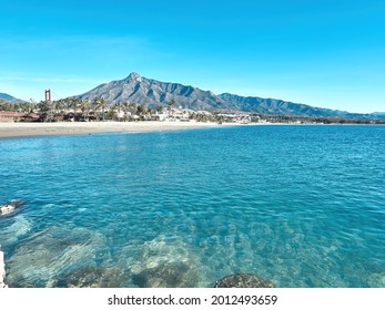 Puerto Banus, Marbella, Spain- July 21, 2020. Puerto Banus beach with blue sky and the shell behind. La Concha is the most famous mountain in Marbella