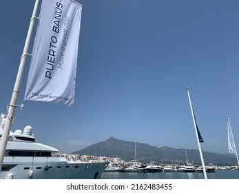 Puerto Banus marina flag and La Concha mountain behind. Puerto Banus, Marbella, Spain. May 14th 2022