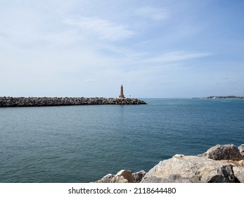 PUERTO BANUS, SPAIN - OCTOBER 11, 2021: Lighthhouse in a breakwater in Puerto Banus, a luxurious marina in Marbella, Malaga province, Costa del Sol, Spain, Europe