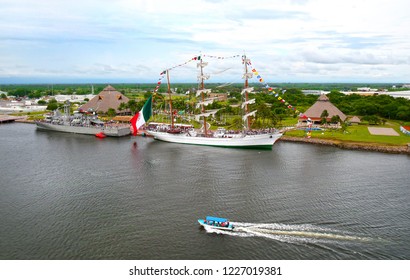 Puerto Chiapas, Mexico.  Mexican Navy Ship And Tall Ship In Port. Flying A Giant Mexican Flag