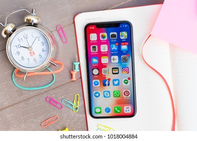 PUERTO CRUZ, SPAIN - JANUARY 04 , 2018: Notebook With New Iphone X Mobile Phone And Alarm Clock