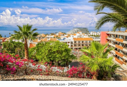 Puerto de Santiago, Tenerife. Sun-drenched coastal town with palm trees, vibrant flowers, and stunning ocean views. Perfect tropical getaway destination. - Powered by Shutterstock