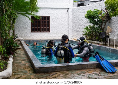 Puerto Galera, Philippines - August 12, 2018: Two Asian Young Girls Have Introduction To The Open Water Scuba Diving Course In A Swimming Pool