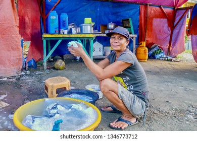 Puerto Galera, Philippines - Dec 1, 2013. Poverty. A Filipino Woman Living Under Plastic Tarpaulins, With A Dirt Floor And Only Basic Necessities, Because She Can't Afford To Pay Rent.