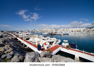 Puerto Jose Banus marina with pier skyline, yachts and sailing boats in Marbella, Costa del Sol, Andalucia, Spain