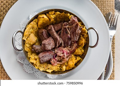 Puerto Rican Beef And Plantains Mofongo Meat Dish. Puerto Rico Food Culture. Mofongo Is A Typical Meal With Fried Cooking Bananas As Its Main Ingredient. Plantains Are Picked, Fried Then Mashed.