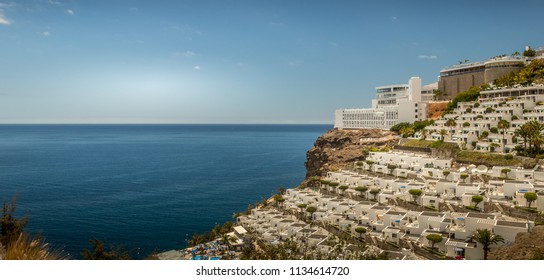 Puerto Rico, Gran Canaria - June 19 2018: The View Of The Walkway To Amadores Beach From The Top Of The Mountain In Puerto Rico 