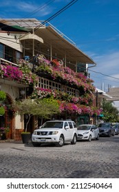 Puerto Vallarta Mexico Nov 27 2021: Building Covered With Blooming Colorful Flowers On A Local Street. Sunny Day, Blue Sky.