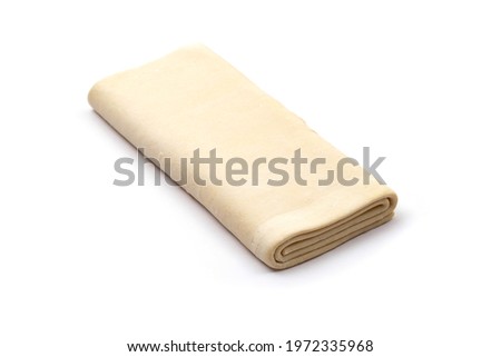 puff frozen dough for baking on a white background, isolate. Close-up
