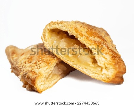 Puff pastry apple turnover triangle confection cut in half with apple bits inside studio shot isolated on white background Foto stock © 