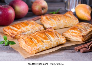 Puff pastry apple pastry turnovers for dessert on a wooden table