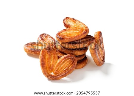 Puff pastry cookies palmier or elephant ears, caramelized and crunchy pastry. Isolated on white background