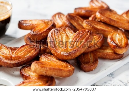 Puff pastry cookies palmier or elephant ears, caramelized and crunchy pastry. White background