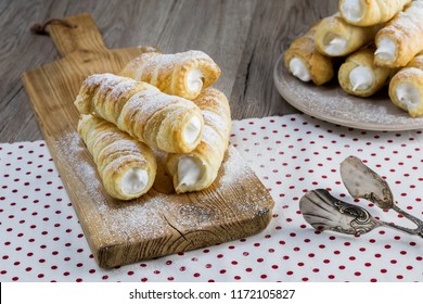 puff pastry creme roll with cream (traditional Czech dessert) on wooden board