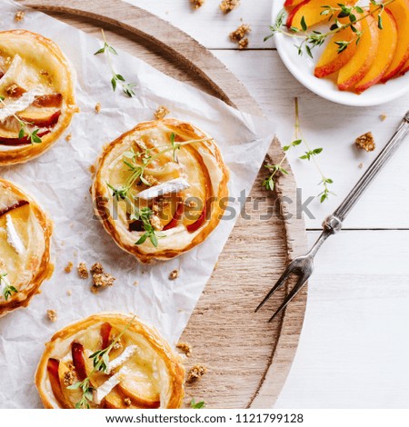 Similar – Puff pastry biscuits with nectarines, camembert and thyme