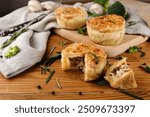 Puff pastry mini  pie on the wooden background.  Savoury meat pie.