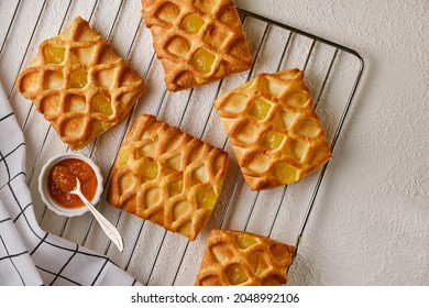 Puff Pastry Mini Pies With With Pear And Lime Jam Filling On Roasting Rack With Fresh With Pear And Lime Slices, Horizontal View From Above, Flatlay