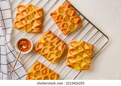 Puff Pastry Mini Pies With With Pear And Lime Jam Filling On A Roasting Rack With Fresh With Pear, Horizontal View From Above, Flatlay