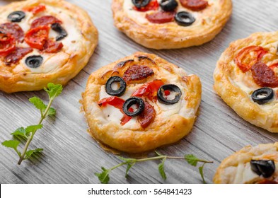 Puff Pastry Mini Pizza With Herbs, Olives And Sausages