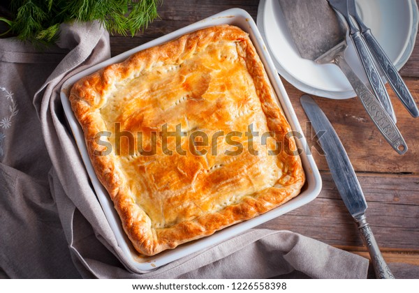 Puff pastry pie with chicken, potatoes\
and onions, quute pie, selective focus, top\
view