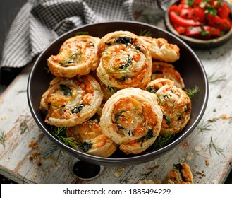 Puff Pastry Pinwheels Stuffed With Salmon, Cheese And Spinach In A Bowl Close Up