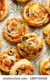 Puff Pastry Pinwheels Stuffed With Salmon, Cheese And Spinach On A Wooden Background Top View