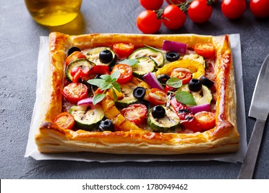 Puff pastry pizza with grilled vegetables. Grey background. Close up. - Powered by Shutterstock